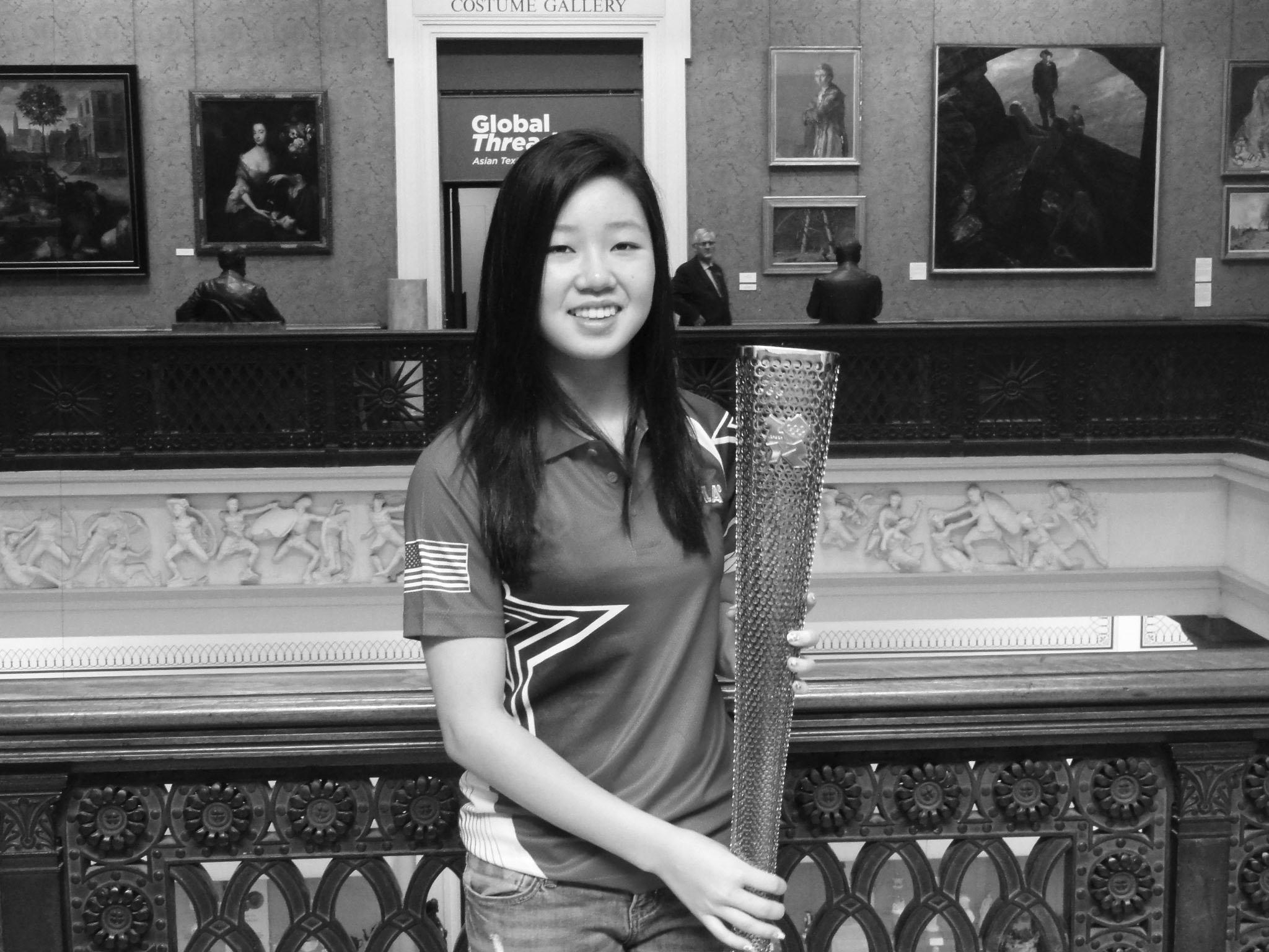 Lily Zhang holds the Olympic Torch in Manchester.