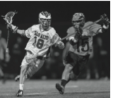 Senior attackman Jonny Glazier takes on his defender as he drives to goal against Woodside High School in a nonleague game. Glazier led the team with nine goals and three assists in that game.