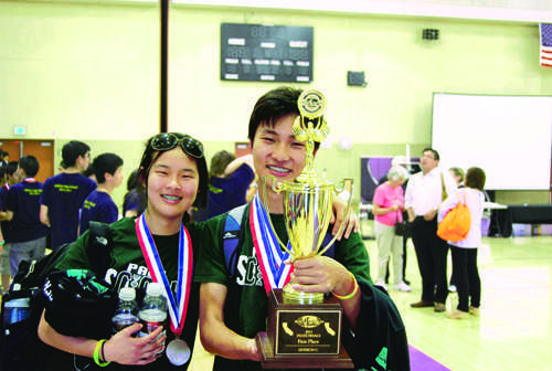 Captains junior Grace Lin and senior Jeffrey Ling pose with their team’s trophy.