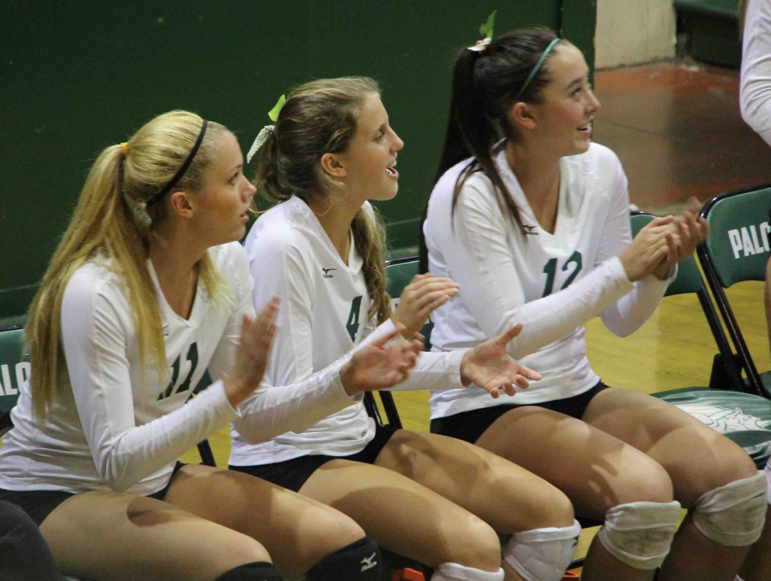 From left: senior Lauren Kerr and juniors Courtney Hartwell and Jade Schoenberger cheer for their teammates as Paly scores a point against the Kings Academy