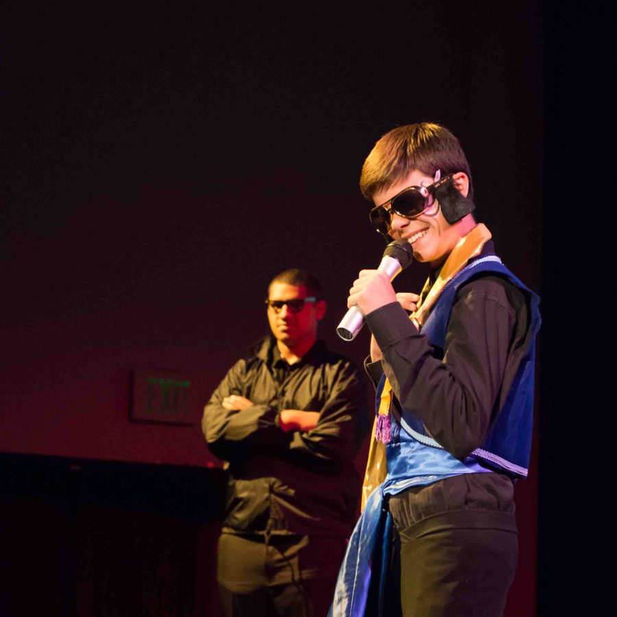 Freshman Johnny Rohrbach sings as he is protected by his bodyguard played by sophomore Carl Wolfgramm.