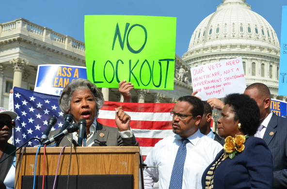 Civilians outside Capitol Hill hold up signs protesting the government shut down, which was the result of a lack of compromise between the Republican and Democratic parties in Congress. 