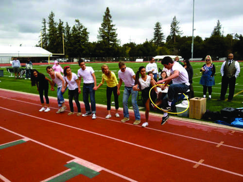 Last year’s Spirit Week participants try to pass through a hula hoop while holding hands.