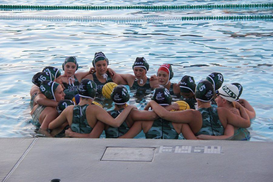 The girls’ water polo  team joins in a huddle to prepare for its game.  The team finished its league season 4-8 and hopes to continue on to CCS.