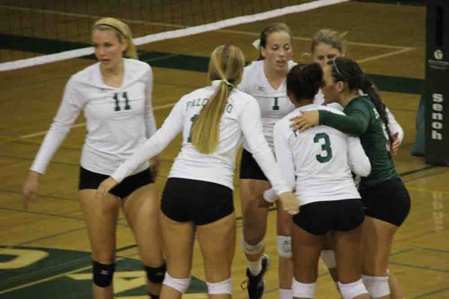 The volleyball team huddles to support each other during a recent match.