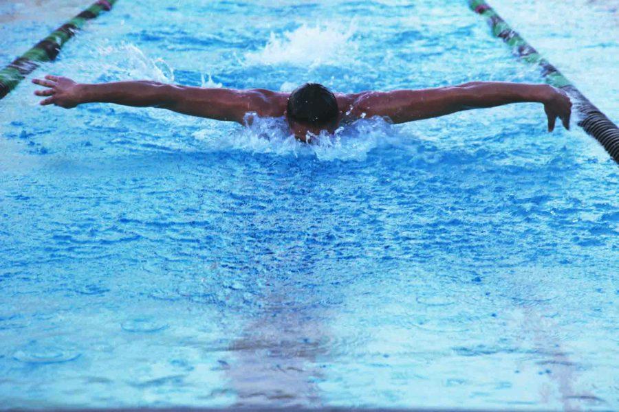 Captain senior Omri Newman practices his butterfly stroke to prepare for the upcoming invitational meet this weekend.