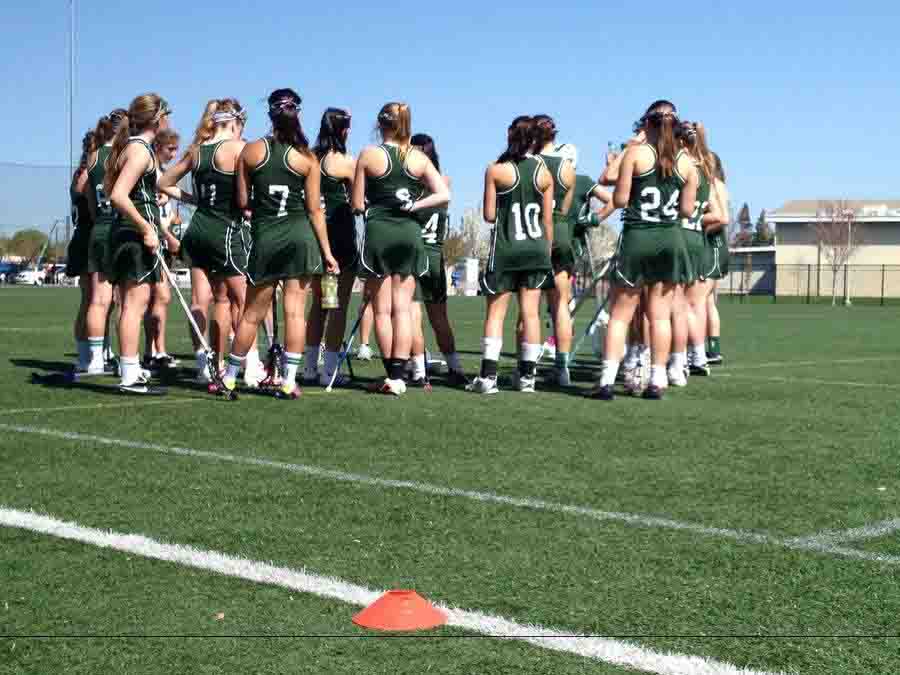 The girls lacrosse team, as pictured taking a break at practice, hopes to close out the season on a strong note against league opponents.