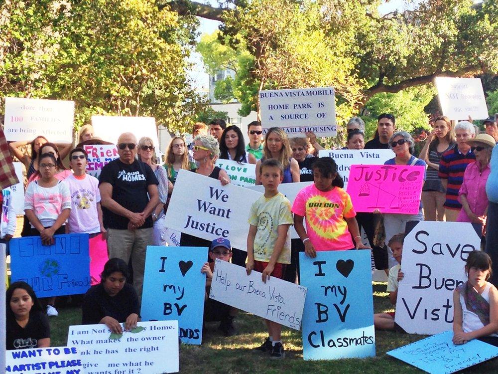 Members of the Palo Alto community peacefully gather at Cogswell Park to show their opposition to the plan to close the Buena Vista Trailer Park on May 12. The group was comprised of educators, local residents and students. 