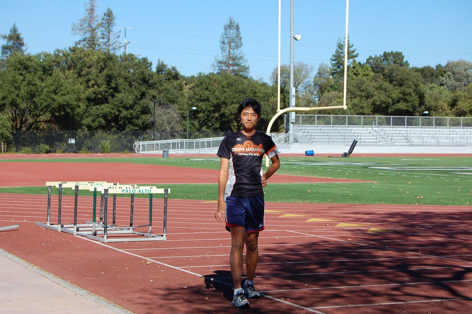 Senior Rick Takeuchi smiles and poses for a photograph before practice on Palo Alto High School cross country team. 