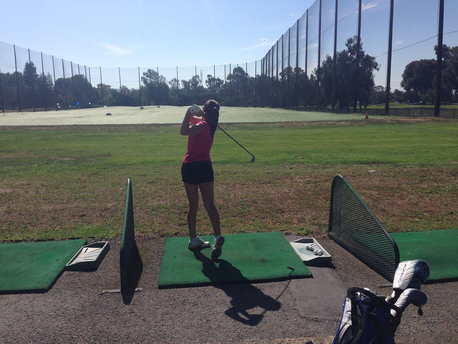 Senior Olivia Johnson fine tunes her driving skills at Shoreline Golf Links .