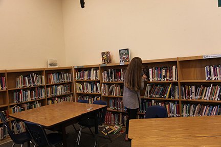 A Jordan Middle School student looks through Jordan’s library. The library was honored on by “The African Library Project” for donating over 13,000 books.