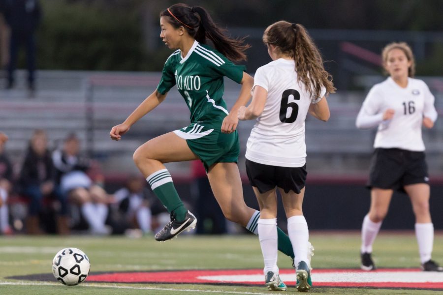 Varsity player Lena Chang fights to keep the ball in control. The girls soccer team’s hard work has earned it numerous wins.
