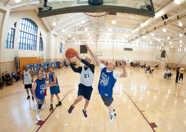 A senior athletes jumps to block a shot during the 2012 National Senior Games. Basketball is just one of the 19 events organized.  