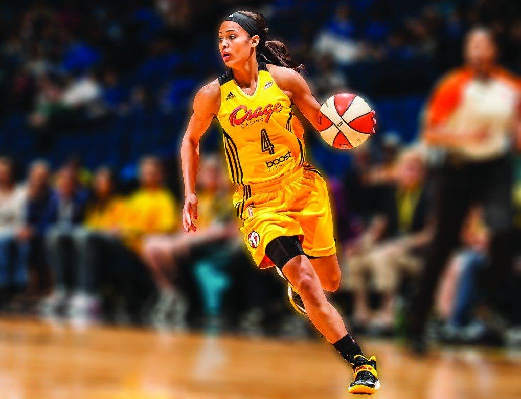 WNBA player Skylar Diggins dribbles down the court.