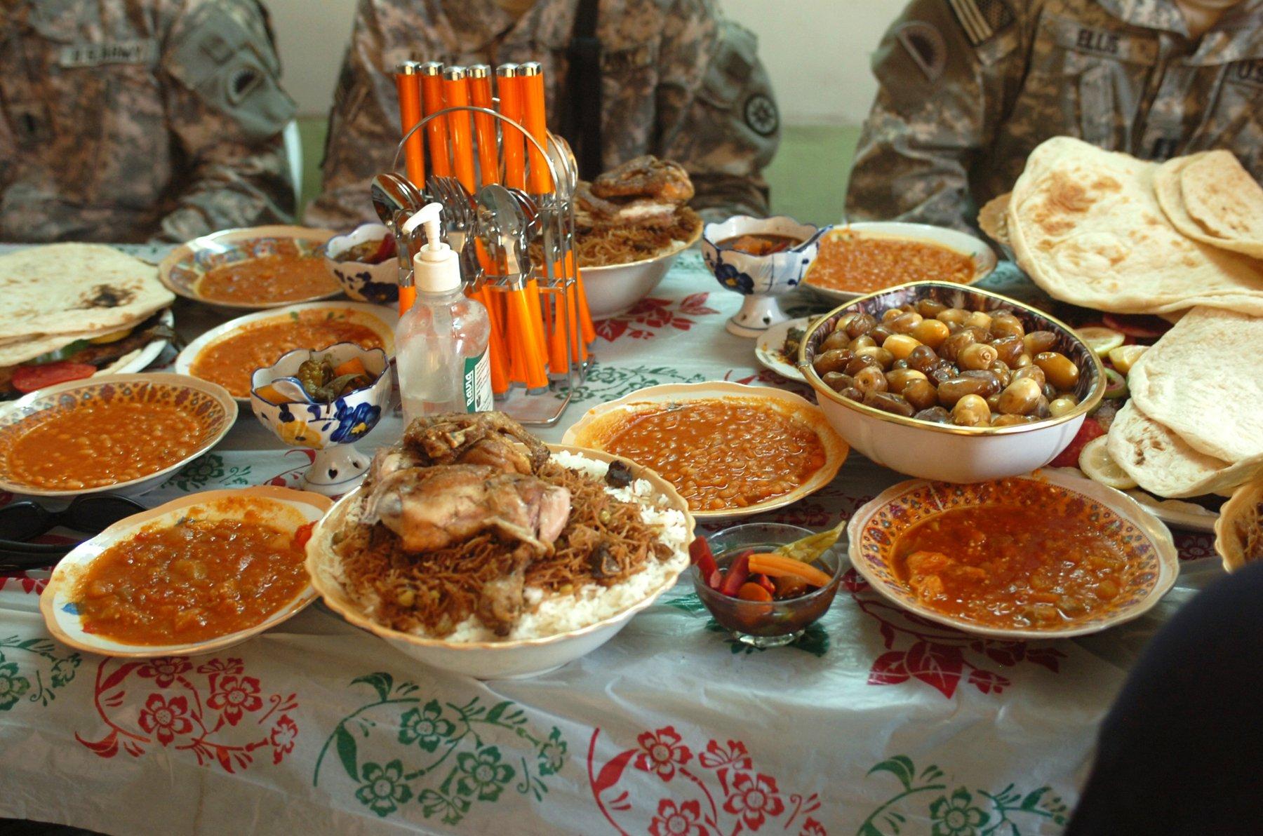 Mr. Ali Jadaan, a local contractor in Scania, Iraq, welcomes members of Alpha Company, 2-162 Infantry, Oregon Army National Guard, into his home for a pre-Ramadan feast. The feast was also an invitaion for the Alpha Company, 2-162 new command to sit and have a non-business meeting. The meal consisted of chicken and rice, soups, fresh fruits and vegetables, pickled vegetables and dates.
