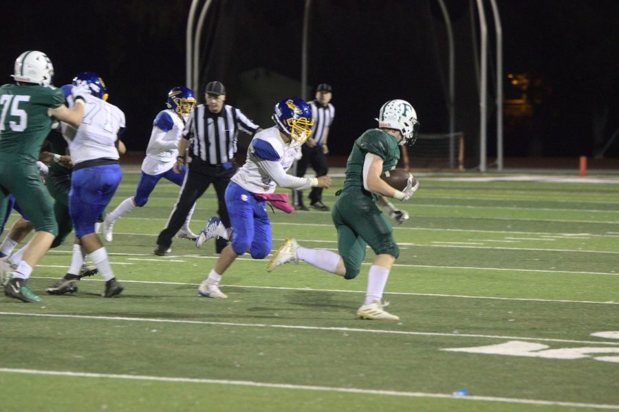 Junior running back Jack Newman evades a defender while rushing towards the end zone in a 63-13 win over Santa Clara.