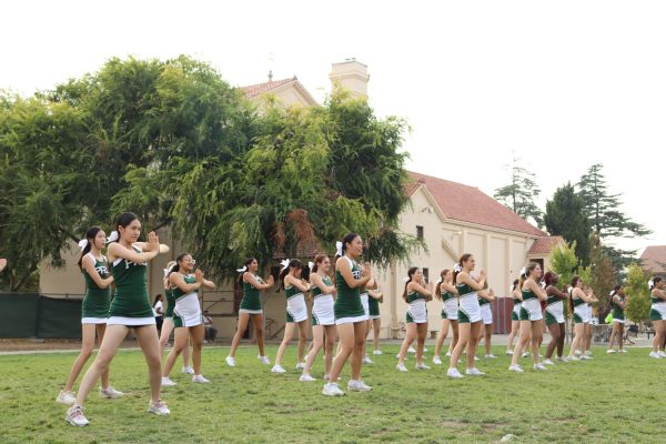 The cheer team performs for parents at the first Parent Fair on Aug. 31. “(This event) is a wonderful opportunity to bring the parent community together and expose (them) to all that Paly has to offer,” PTSA Vice President of Community Activities Esther Yoo said.
