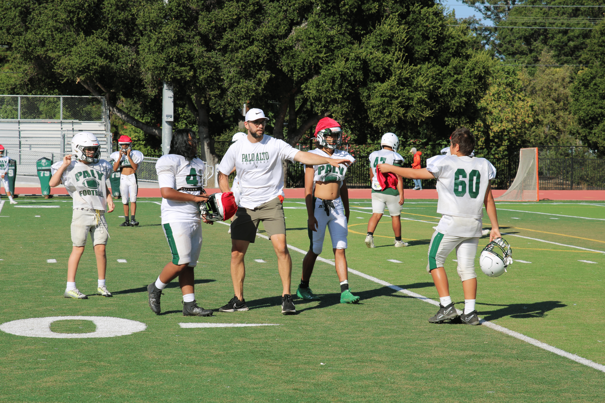 Former Stanford and Indianapolis Colts star Andrew Luck directs players at a  JV football practice. “ It’s been amazing to get NFL coaching experience because he has so much knowledge that he spreads to everyone, and practices have been a lot smoother since he’s been here,” sophomore wide receiver Dylan Robinson said.