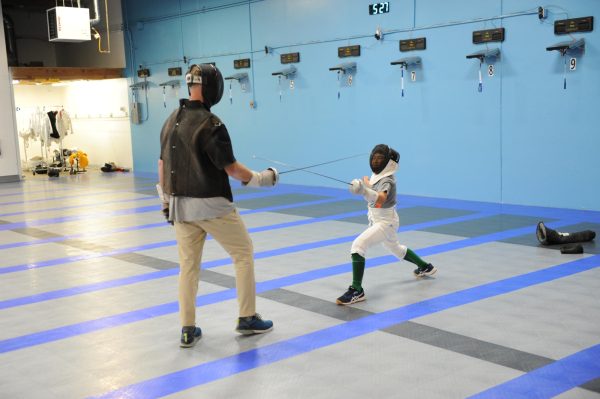 A fencer practices a lunge. “Regardless of your age or gender, fencing is easy to pick up,” Bayside Fencing Club co-owner Xin Zhang said.