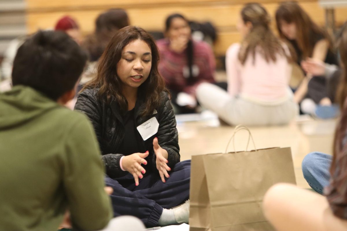Senior Lucianna Peralta talks with her peers at Breaking Down the Walls. “It was really nice to connect with people who I never would have talked to, and then get friends that you would never, never expect, Freshman Clara Manolache said.