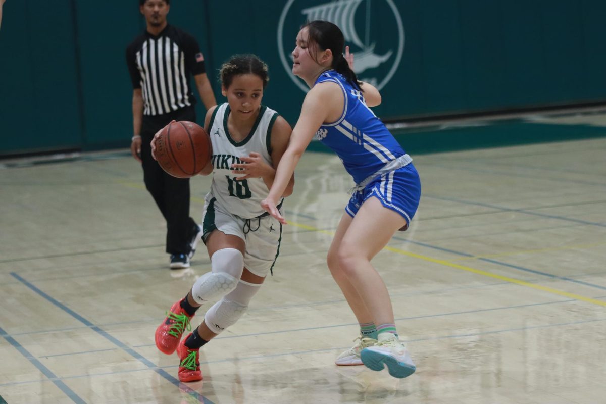 Junior Karina Ashford dribbles the ball past a defender. Freshman and captain Eliana Miao said, “We’re just trying to learn how to just get better every day and then keep working because eventually the work will pay off.”