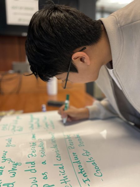 Sophomore Brendan Giang outlines his winning project  on a whiteboard. Giang said, “I’ve never put this much effort into something like filmmaking and documentary making before.”