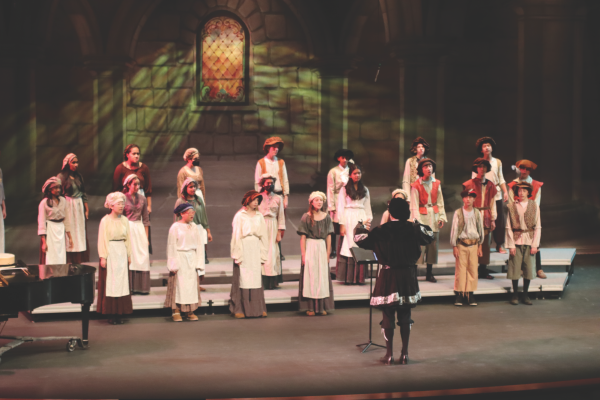 Michael Najar directs Paly Choirs production of the Madrigals. “We all want every kid to have access to (theatre),” theatre teacher Sarah Thermond said.