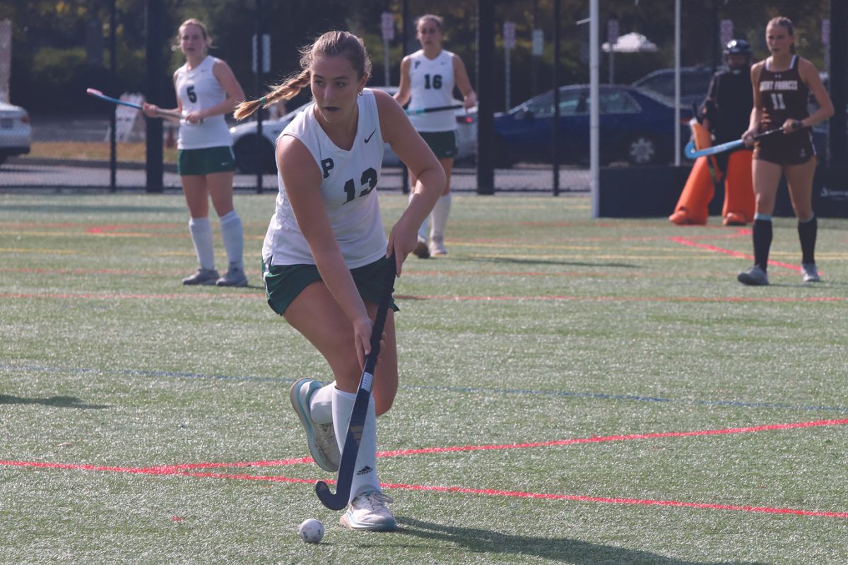 Senior Lucy Griffin dribbles the ball up the field and prepares to pass to her teammate. “We have a lot of new players and a new coach, but it is going really well so far, and I think we are going to do great,” junior Sarah Thieman said.