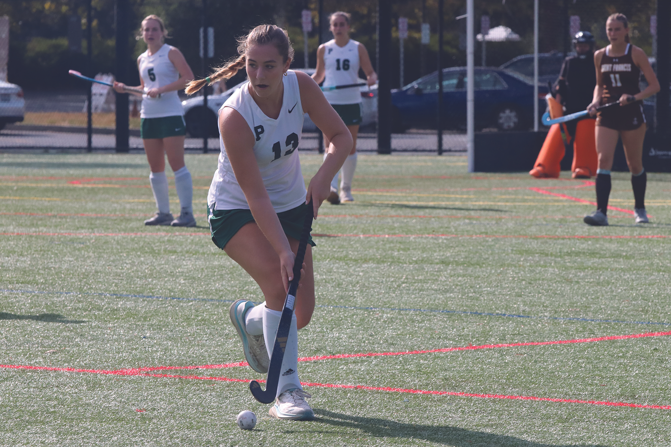 Senior Lucy Griffin dribbles the ball up the field and prepares to pass to her teammate. “We have a lot of new players and a new coach, but it is going really well so far, and I think we are going to do great,” junior Sarah Thieman said.