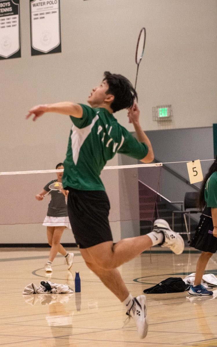 Senior and co-captain Andrew Li prepares to deliver a smash against his opponent during his match. “Coming into the game, I just wanted to have a good game on my senior night,” Li said.