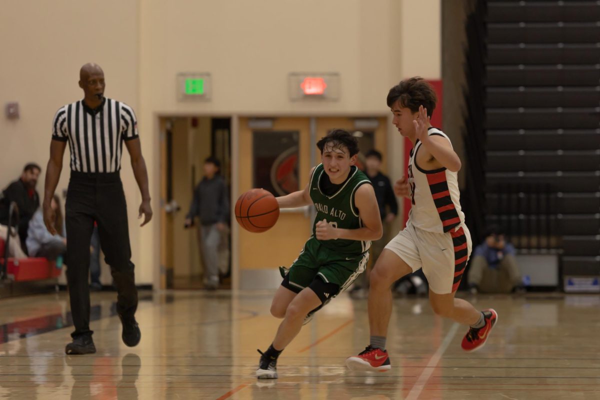Junior Rocco Smith dribbles against Gunn. Smith said exhaustion affected how they played, “I thought it was a bit sloppy, but overall we did a good job” Smith said.