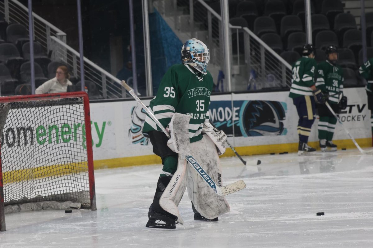 Junior Miles Joing prepares to block a shot. “When I get to the rink and into the locker room, everyone is having a good time,” Joing said. “Then, getting on the ice, our team just works so well together, which makes the whole experience a nice pause from school, among other things.”