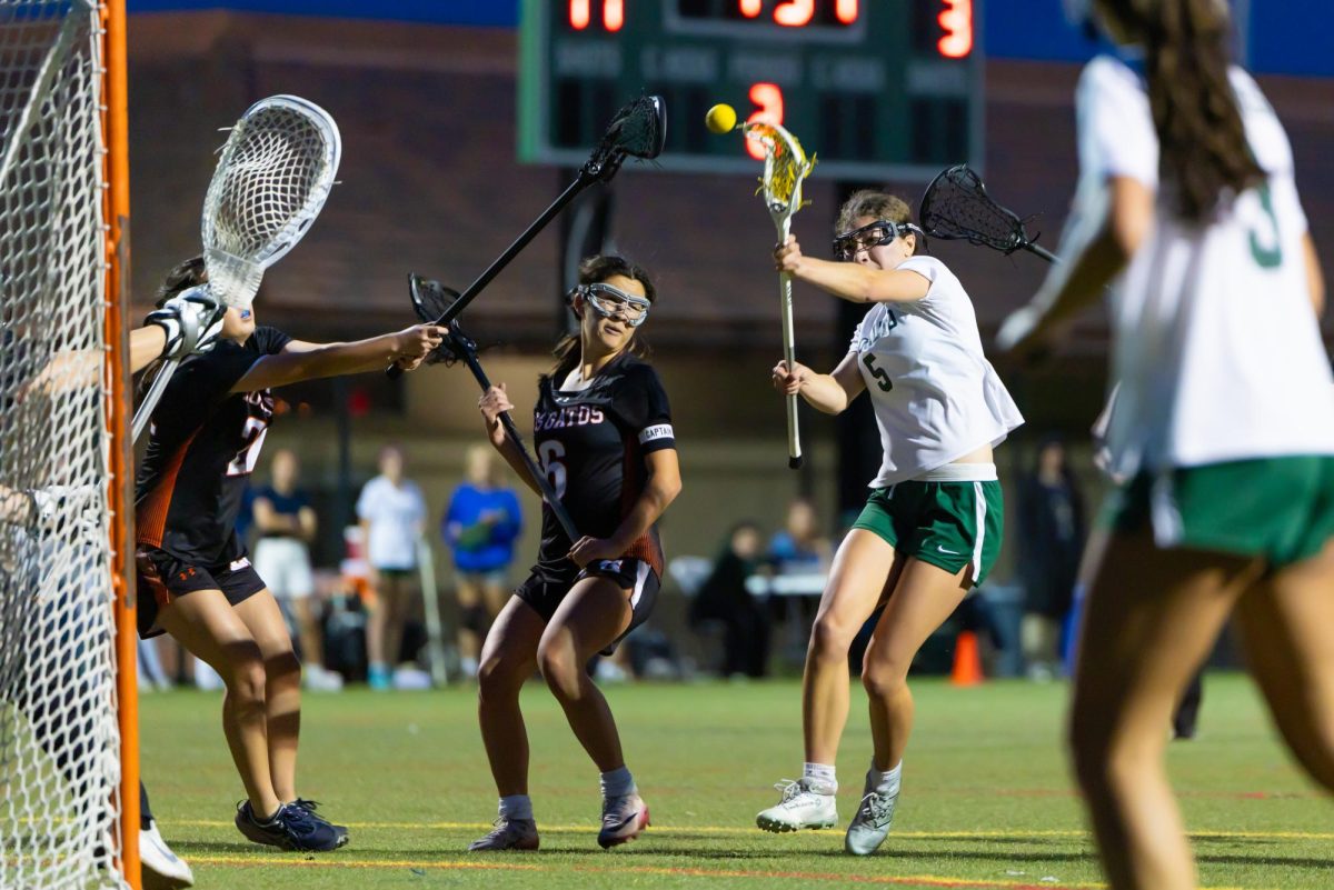 Freshman Hanna Karsner shoots and scores against Los Gatos in the second half, her goal was one of nineteen that Palo Alto scored against Los Gatos. Head Coach Kaitlin Chu said that the team needed to adapt their zone defense at first. “We also didn’t know what to expect from their defensive standpoint,” Chu said. “We had to figure out how to get open given that they were playing zone defense.”