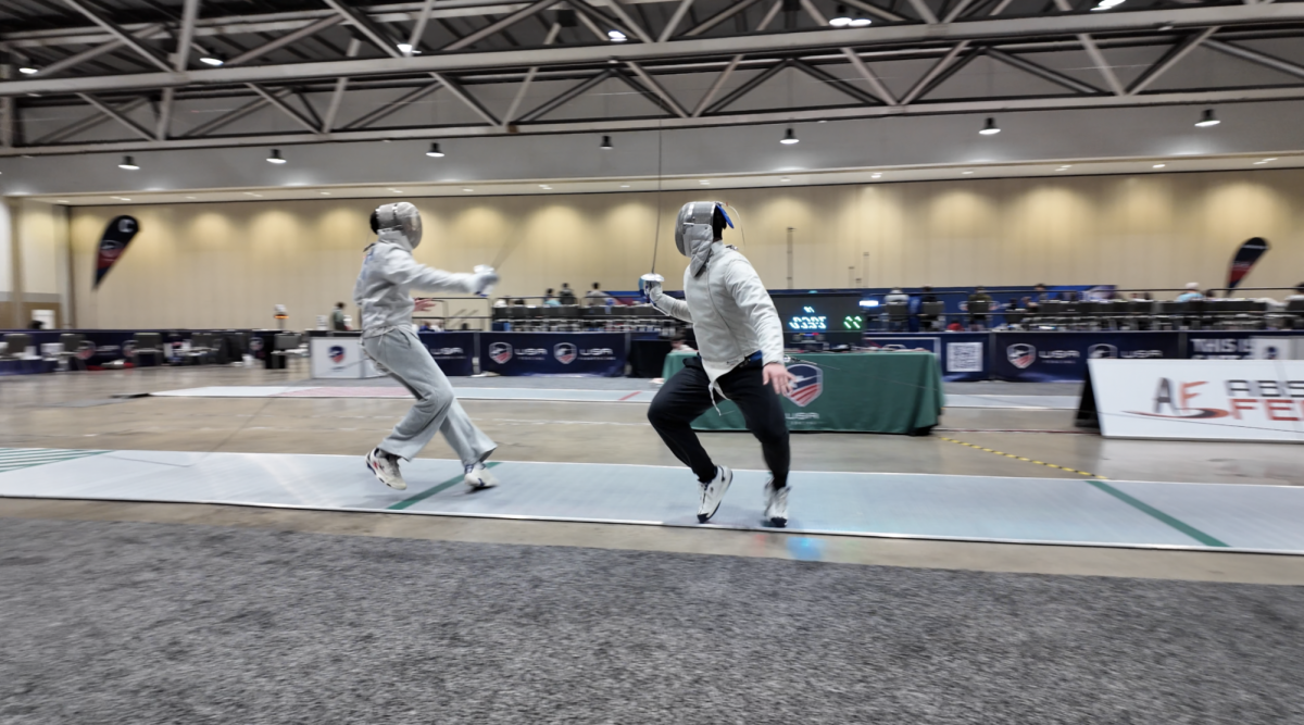 Sophomore Henry Chan (right) bouts against a friend at the Kansas City Convention Center to practice for the Junior Olympics. “I fence sabre, so my target area is waist up, including the head and arms. It’s the fastest one, and the only one where you can slash your opponent instead of poking them,” Chan said.